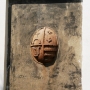 Wmurowana w zewnętrznej ścianie tarcza herbowa ze zniszczonego w latach 1659-1660 pomnika nagrobnego Piotra Wiesiołowskiego- młodszego, zmarłego w 1621r. Górne pola tarczy zajmują herby Wiesiołowskich-Ogończyk i Wołłowiczów-Bogoria. Pod nimi herby- Jastrzębiec i Korczak