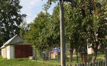 Drewniany krzyż przydrożny, obok mały żelazny
